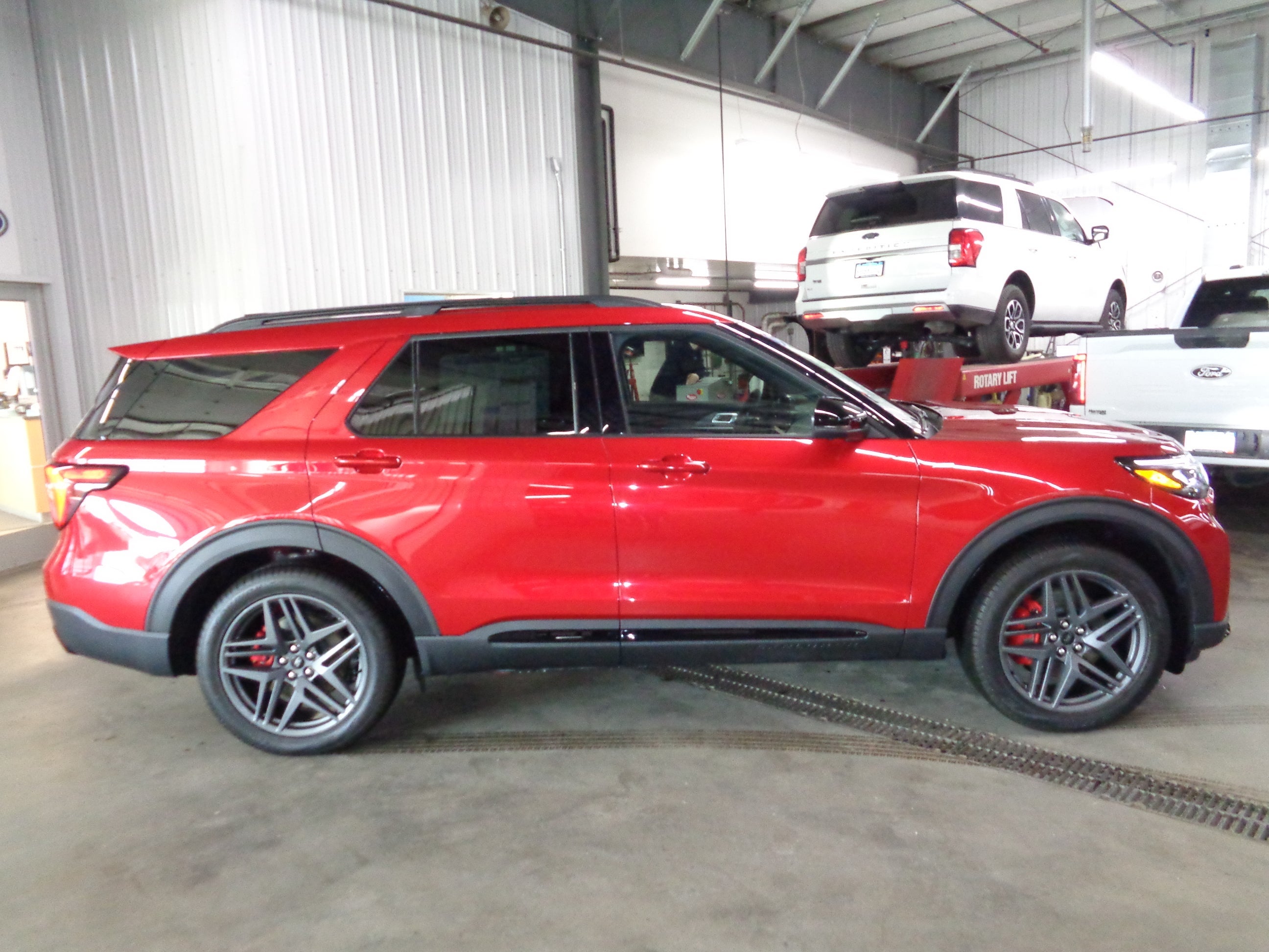2026 Ford Explorer ST-Line in Rapid Red Metallic Tinted Clearcoat — front three-quarter view